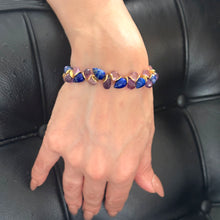 Load image into Gallery viewer, Multicolored gemstone bracelet with gold accents on a wrist