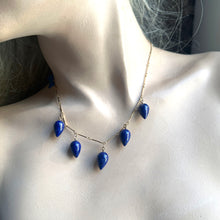 Load image into Gallery viewer, A gold chain necklace with five teardrop-shaped dark blue lapis lazuli stones, displayed on a mannequin bust.
