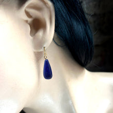 Load image into Gallery viewer, Blue teardrop earring on a mannequin ear with dark hair.
